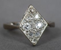 An Art Deco white gold diamond set ring Of lozenge form. 1.5 cm high.