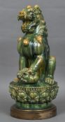 A Chinese pottery figure of a temple lion Modelled seated, playing with a cub, on plinth base.