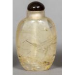 A rock crystal snuff bottle Of typical ovoid form with a brown glass lid. 6.75 cm high.