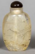 A rock crystal snuff bottle Of typical ovoid form with a brown glass lid. 6.75 cm high.