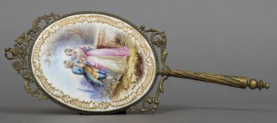 A 19th century French hand mirror The scroll cast frame surrounding the bevelled plate,