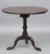 A George III mahogany bird cage tilt top tripod table The circular top above the typical bird cage