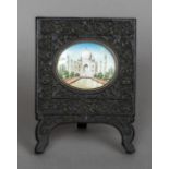 A 19th century miniature on ivory depicting the Taj Mahal Housed in a carved ebony frame. 10.