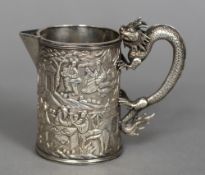 A late 19th century Chinese unmarked silver beaker With scrolling dragon form handle,