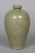 A Chinese porcelain vase With allover celadon glaze and incised decoration of a fish amongst reeds.