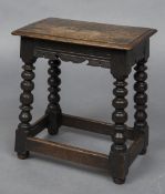 A 17th century style oak joint stool The moulded rectangular top above the carved frieze,