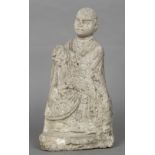 A Chinese Ming stone model of a deity Formed seated with clasped hands. 47 cm high.