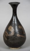 A Chinese porcelain baluster vase With stylised decoration on a black ground. 30 cm high.