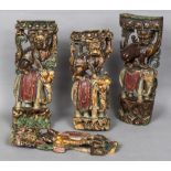 Four 19th century Chinese painted carved wooden uprights Each formed as a dog-of-fo astride and