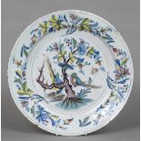 A 19th century Delft polychrome painted charger Decorated with birds amongst floral boughs. 36.