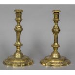A pair of 18th century French gilded candlesticks With scroll cast chamfered stem above the