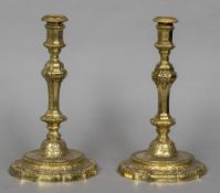 A pair of 18th century French gilded candlesticks With scroll cast chamfered stem above the