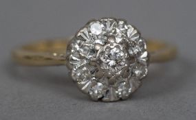 An 18 ct gold and diamond ring Of flowerhead cluster form.