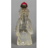 A Chinese carved rock crystal snuff bottle Formed as a man with a red porcelain lid. 8.25 cm high.