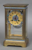 A French gilt metal four glass mantel clock The champleve decorated dial with Arabic numerals,