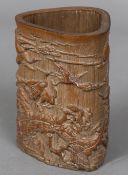 A Chinese carved bamboo brush pot Worked with birds in a continuous landscape. 14 cm high.