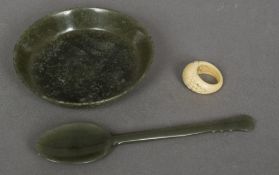 A Mughal style carved spinach jade dish and spoon With arabesque finial;