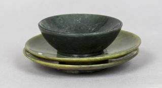 A pair of Chinese spinach jade bowls Together with a pair of spinach jade saucers.