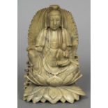 A Chinese carved soapstone group Worked as Guanyin seated with child attendant. 18 cm high.