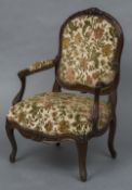 A 19th century carved rosewood open armchair The carved top rail above the padded back and padded