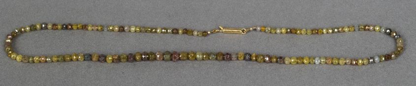 A natural multi-coloured diamond necklace The graduated beads facet cut and with 18 ct gold clasp.