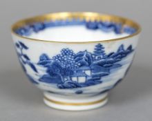 An English blue and white porcelain tea bowl Decorated with a continuous landscape and with gilt