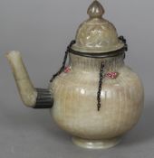 An 18th/19th century Indian Mughal white and yellow metal mounted gem set carved jade teapot and