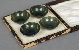 A cased set of four Chinese carved spinach jade bowls Each 6 cm diameter.