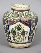 A 19th century Qajar pottery vase Of ovoid form, with floral and bird filled decorations.