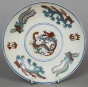 A Chinese porcelain saucer dish Decorated with mythical beasts and flaming pearls,