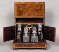 A 19th century French brass inlaid amboyna decanter box Of serpentine form with removable fitted