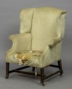 A 19th century mahogany wing back armchair The overstuffed back between twin padded wings and arms