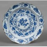 Am 18th/19th century Delft blue and white charger With floral and fruit decorations with a domed