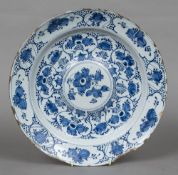 Am 18th/19th century Delft blue and white charger With floral and fruit decorations with a domed