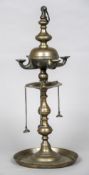 An 18th/19th century Eastern bronze oil lamp The reservoir issuing four spouts. 50 cm high.