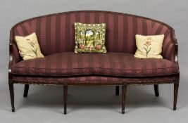 A 19th century mahogany framed Hepplewhite style settee The curved top rail above the overstuffed