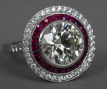 A diamond and ruby set platinum target ring The central stone approximately 3.5 carats.