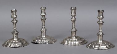 A set of four antique Continental silver candlesticks,