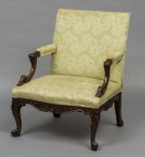 A 19th century mahogany framed Gainsborough armchair The overstuffed back issuing padded acanthus