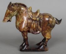 A Chinese carved russet jade model of a horse Worked in the Tang style. 19.5 cm high.