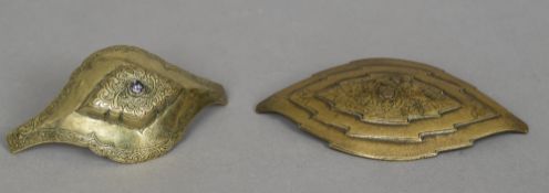 Two 19th century Eastern brass buckles Both with engraved decoration, one set with a clear stone.