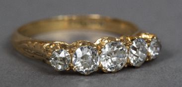 An 18 ct gold diamond set five stone ring The central stone approximately 0.5 carat.