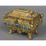A Continental gilt metal cast casket The hinged cover and bombe body scroll cast and with inset