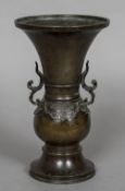 A Chinese bronze twin handled vase Of flared form with scroll cast handles and lappet band,