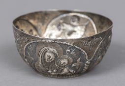 A near Eastern embossed white metal bowl,