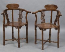 A pair of Chinese carved hardwood faux bamboo corner chairs Each with pierced back splats and