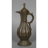 A 19th century Ottoman brass ewer Of ribbed baluster form with engraved scroll decoration,