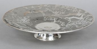 A glass tazza With silver overlay decoration depicting deer amongst flowering boughs,