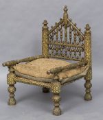 A 19th century Kashmiri open armchair Typically decorated and with a caned seat,