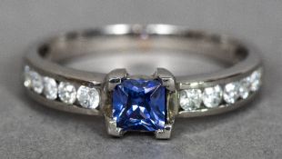 An 18 ct white gold, diamond and tanzanite ring With central claw set tanzanite,